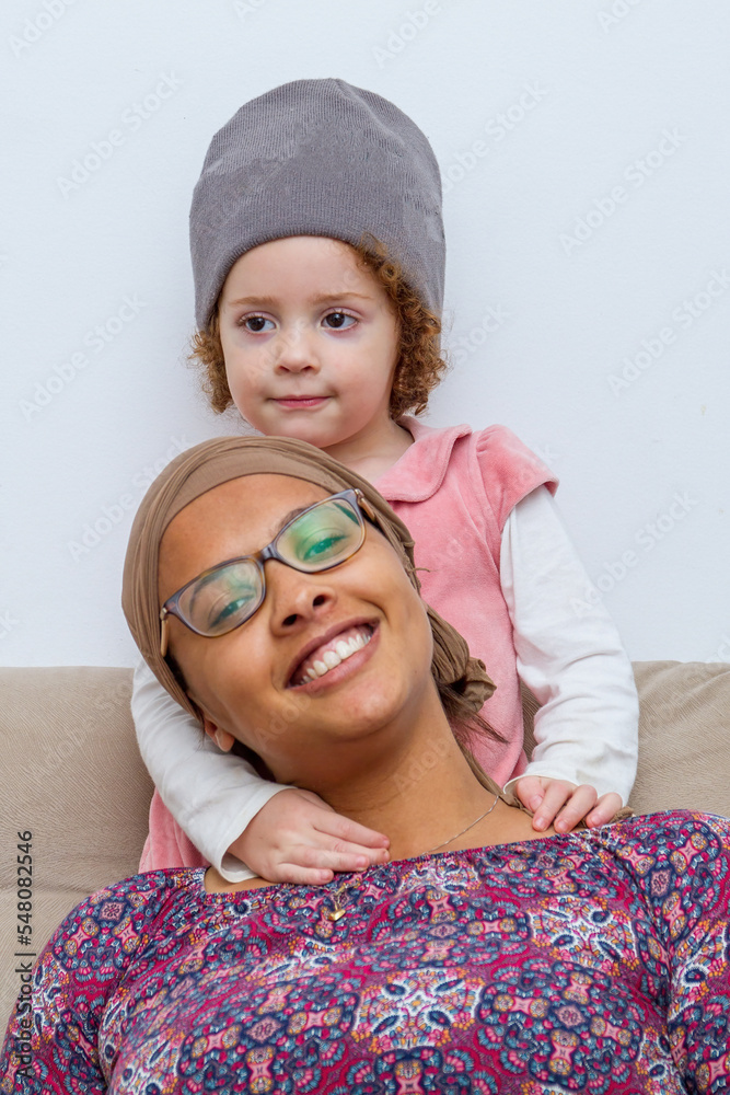 Close up biracial family portrait loving black mother and caucasian daughter at home smiling and happy. Mother's love for the affectionate child