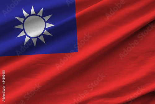 Taiwan flag with big folds waving close up under the studio light indoors. The official symbols and colors in banner photo