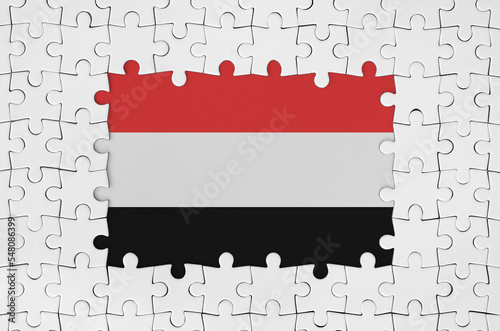 Yemen flag in frame of white puzzle pieces with missing central part photo