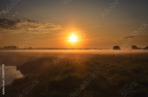 Beautiful morning foggy landscape. Sunrise over the river in Ponidzie in Poland.