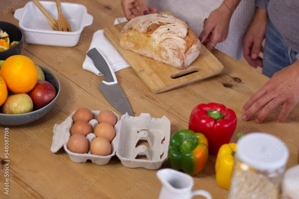Close-up of table with healthy food and human hands on it. View of wooden table with fresh products on it prepared by young man and woman for cooking meal. Healthy lifestyle, food and cooking concept Close-up of table with healthy food and human hands on it. View of wooden table with fresh products on it prepared by young man and woman for cooking meal. Healthy lifestyle, food and cooking concept