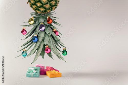 Creative New Year's composition with a pineapple tree and Christmas decoration. Vacation concept. Modern collage on a white background. Creative art minimal aesthetics