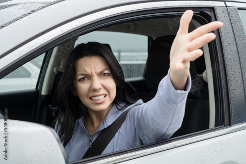 talking driver inside a car. Portrait of an aggressive young woman. Concept Road trip Insurance accident.