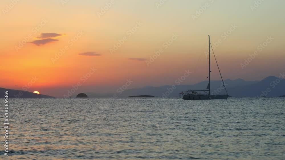 Sailboat at sea. Seascape golden sunrise over the sea. Yacht sailing in the sunrise time. Sea landscape view with a beautiful sailboat. Yachting tourism sea voyage on the sail boat. Sailboat at sea. Seascape golden sunrise over the sea. Yacht sailing in the sunrise time. Sea landscape view with a beautiful sailboat. Yachting tourism sea voyage on the sail boat.