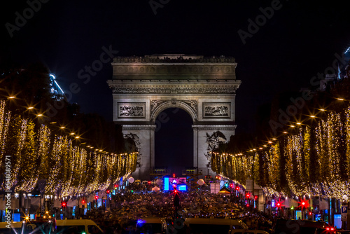 Paris, France - November 20, 2022: Christmas time, the decoration along the Avenue des Champs Elysees with Arc de Triomphe in background in Paris, France