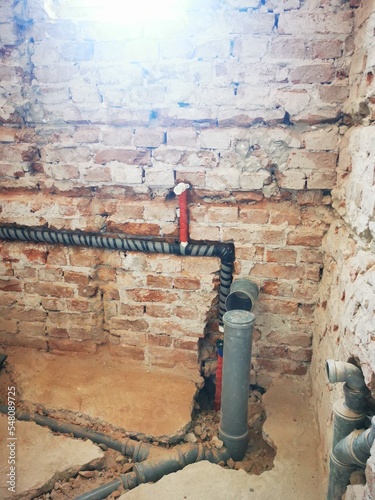 Bathroom construction at renovated home. Installation of pipes in bathroom. pipe line inside wall photo