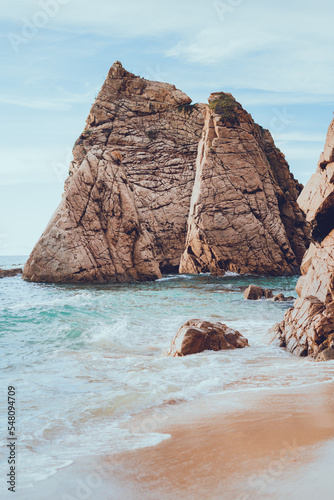 an extremely beautiful and secluded beach on the ocean coast in Portugal. rocks on the ocean shore.