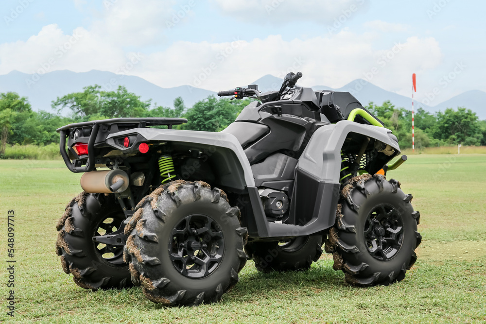 Modern quad bike on green grass outdoors