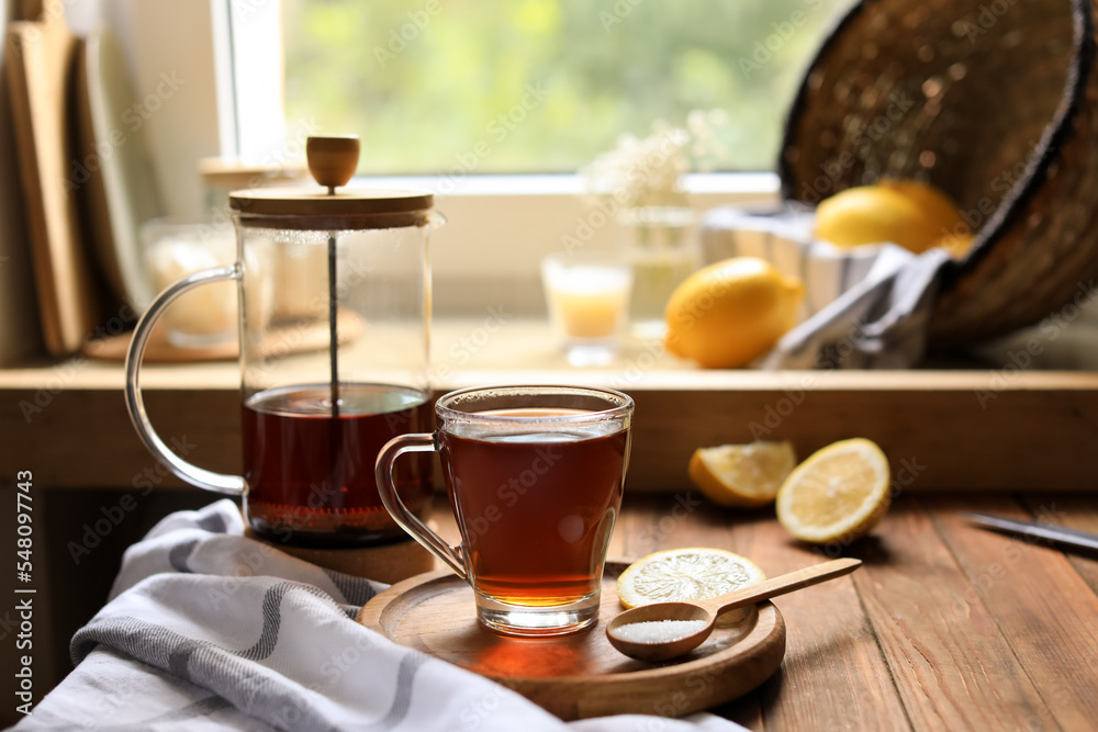Delicious tea, sugar and lemon on wooden table, space for text