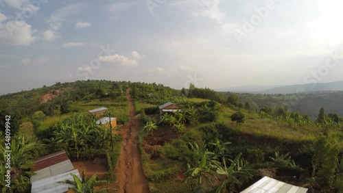 Aerial over remote village and farm land in Rwanda, Africa on green mountain top photo