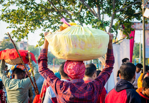 devotee carrying offerings for sun god during Chhath festival from flat angle