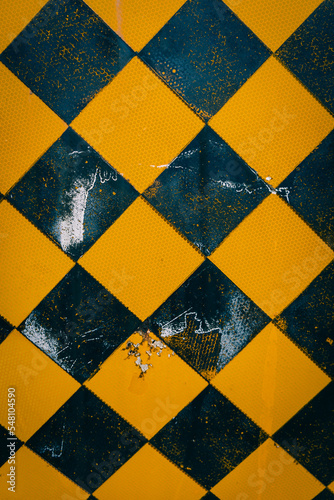 Yellow and black checkerboard pattern sign