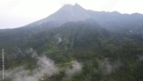 Aerial view of the slopes of Mount Merapi as seen from the Klangon Hill camping ground covered in clouds in the morning. photo