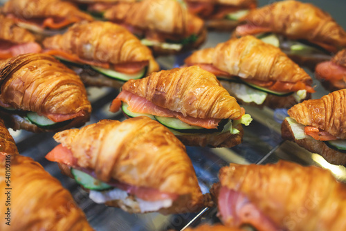 Catering table, beautifully decorated banquet table with variety of different food snacks, sandwiches, croissants and appetizers on party event or celebration, delicatessen setting, coffee break