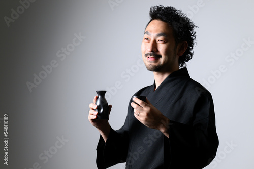 Japanese man toasting sake (Japanese alcohol),  photo