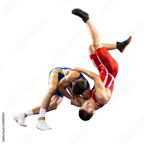 Two young men in blue and red wrestling tights are wrestlng and making a suplex wrestling on a white background photo