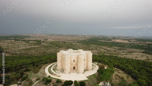 Drone flying in large circulair motion around Castel del Monte in the early morning in the south of Italy in 4k photo