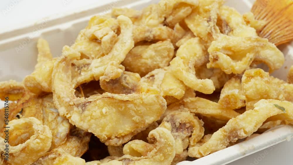 Fried crispy red tilapia in white disposable box rotating. Fried crispy red tilapia in white disposable box rotating.