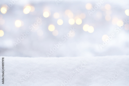 Blurred Christmas lights and snow. Winter background, glitter defocused lights, bokeh, Snowflakes and snowfall © maxa0109
