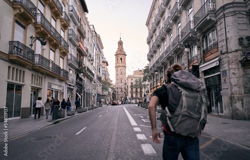 young caucasian man with big backpack on his back walking on a city street, valencia, spain © FranciscoJavier