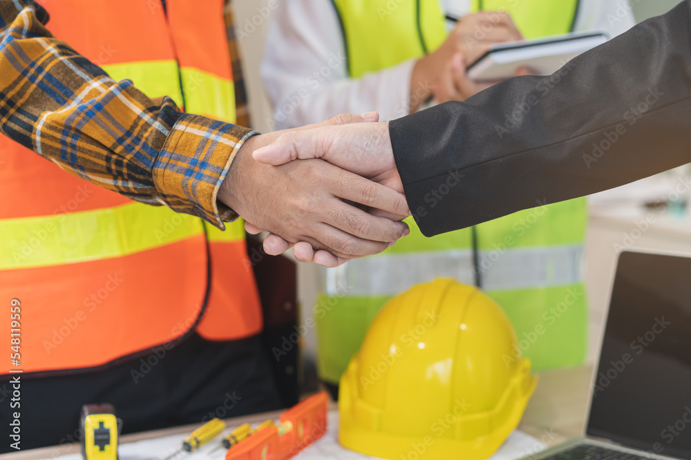 Successful team building, two asian young man builder group use hand handshake together at office after home project done, good deal. Happy business people, Worker meeting, shaking hands and success. Successful team building, two asian young man builder group use hand handshake together at office after home project done, good deal. Happy business people, Worker meeting, shaking hands and success.