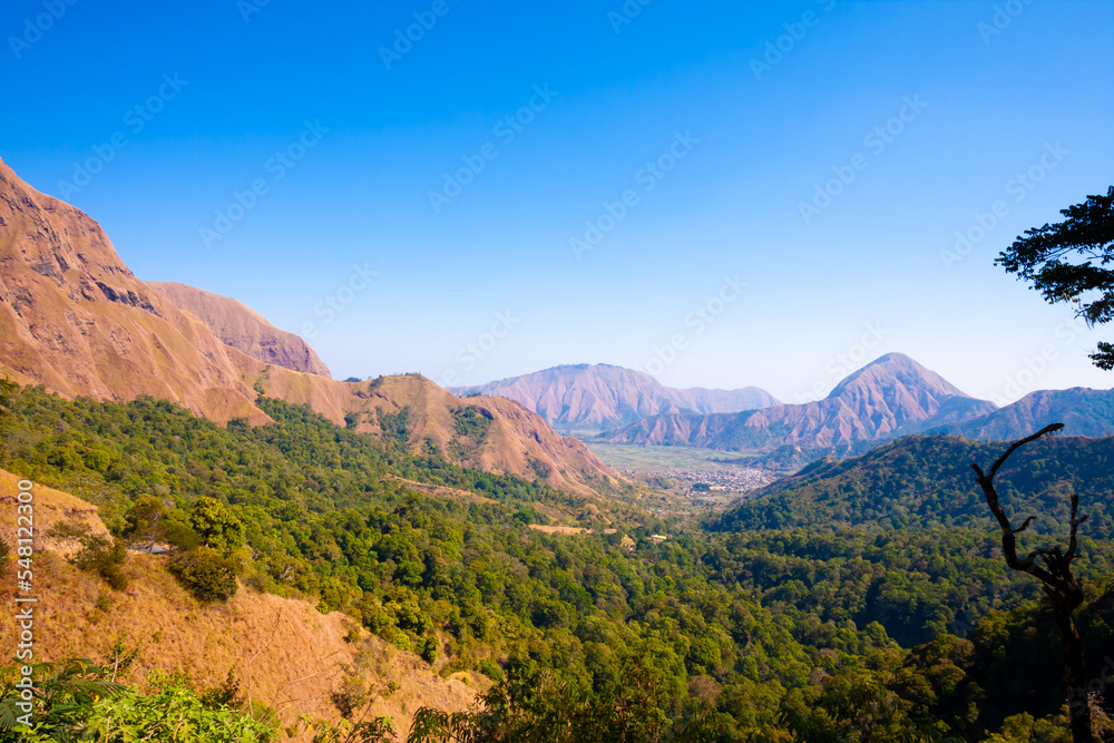 Travel photo with back ground mountain scenery and green forest.