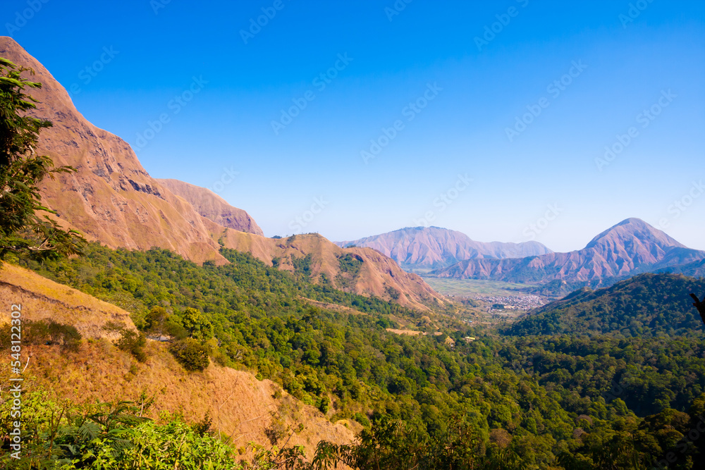 Travel photo with back ground mountain scenery and green forest.