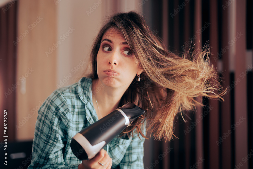 Woman Drying her Hair Using Heat Worried about Healthy Hair. Stressed