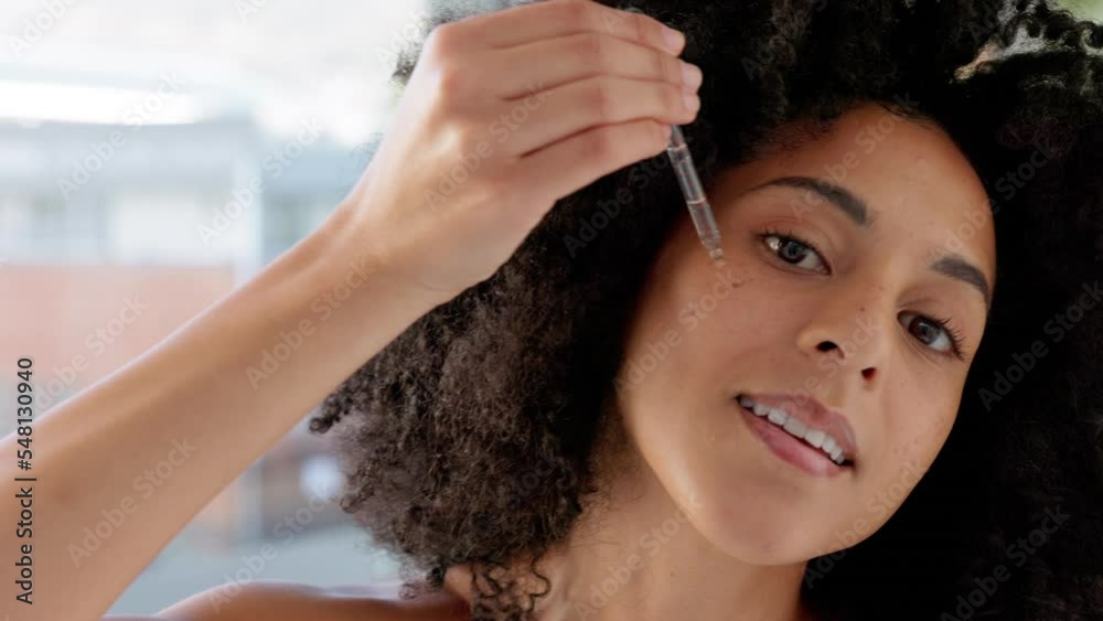 Skincare, beauty and black woman with face serum in bathroom for glowing skin. Wellness, health and female apply hyaluronic oil with pipette or dropper product for facial treatment or moisturizing.
