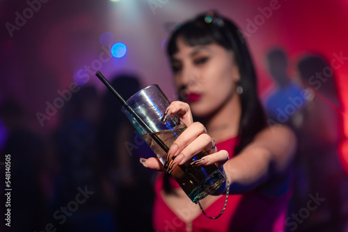 a beatiful girls posing for a photo at a party. Young people dancing in night club party. selective focus. Long exposure. Moving lights. party concept. Party night club. Nightclub.