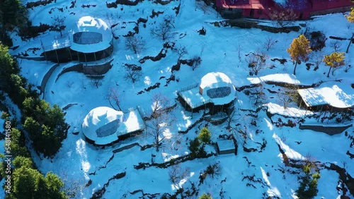 Mussoorie,Uttarakhand India- January 15 2022- Aerial winter landscape of trees and fields covered in snowfall . Snowfall in Mussoorie, Uttarakhand India. Aerial view of beautiful snow-covered