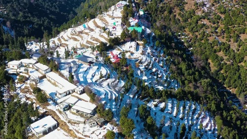 Mussoorie,Uttarakhand India- January 15 2022- Aerial winter landscape of trees and fields covered in snowfall . Snowfall in Mussoorie, Uttarakhand India. Aerial view of beautiful snow-covered