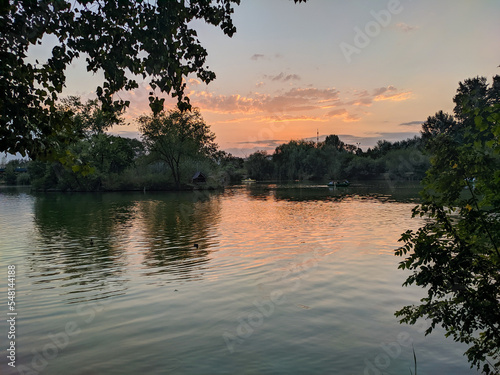 Pyatigorsk, Russia - August 28, 2022: People go boating in the Kirov Park of Culture and Leisure in the city of Pyatigorsk against the backdrop of sunset