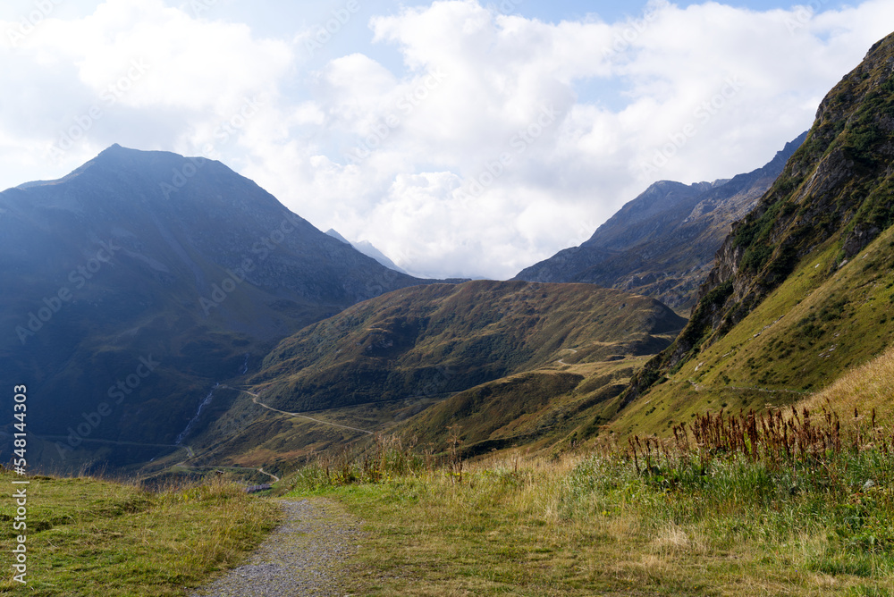 Hiking trail with scenic landscape at region Oberalppass Surselva on a blue cloudy late summer day. Photo taken September 5th, 2022, Oberalp Pass, Switzerland.