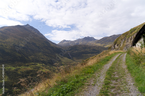 Hiking trail with scenic landscape at region Oberalppass Surselva on a blue cloudy late summer day. Photo taken September 5th, 2022, Oberalp Pass, Switzerland.