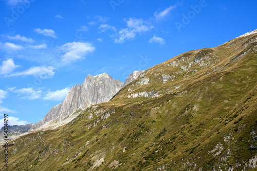 Mountain panorama with peak at Swiss mountain pass Oberalppass on a sunny late summer morning. Photo taken September 5th, 2022, Oberalp Pass, Switzerland.