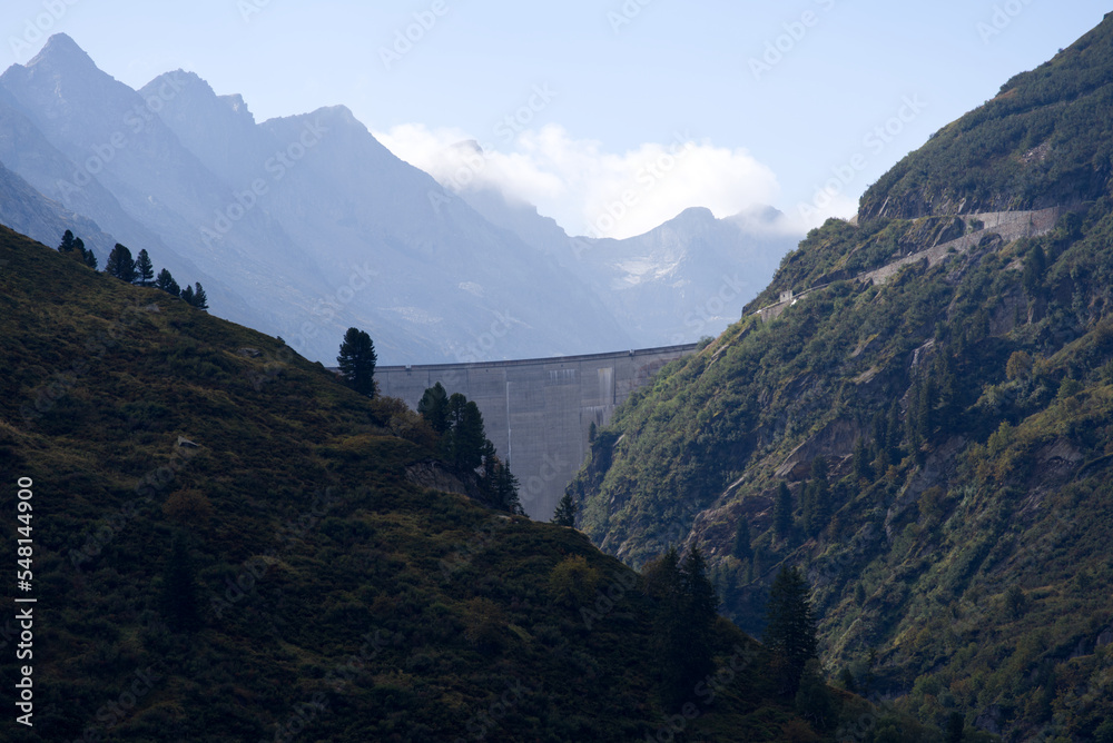 Dam Lai de Curnera in the Swiss Alps at side mountain valley of mountain pass Oberalppass on a blue cloudy late summer day. Photo taken September 5th, 2022, Oberalp Pass, Switzerland. Dam Lai de Curnera in the Swiss Alps at side mountain valley of mountain pass Oberalppass on a blue cloudy late summer day. Photo taken September 5th, 2022, Oberalp Pass, Switzerland.