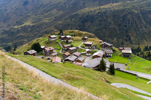 Aerial view of mountain village Tschamut in the Swiss Alps at region of Oberalppass on a blue cloudy late summer day. Photo taken September 5th, 2022, Oberalp Pass, Switzerland. photo