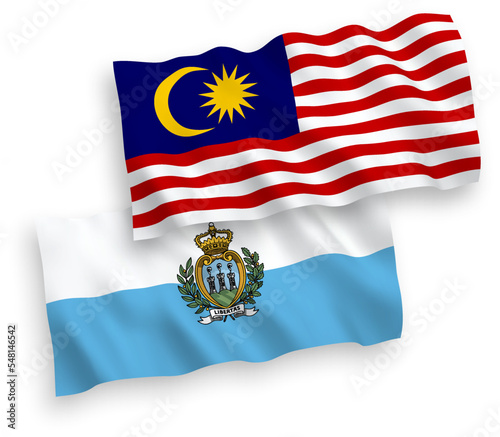 National vector fabric wave flags of San Marino and Malaysia isolated on white background. 1 to 2 proportion. © epic