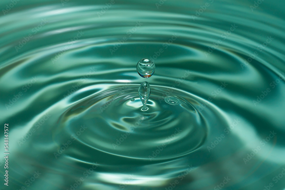 Circles on the water from a fallen drop of water. Blue, aquamarine background. High quality photo Circles on the water from a fallen drop of water. Blue, aquamarine background. High quality photo