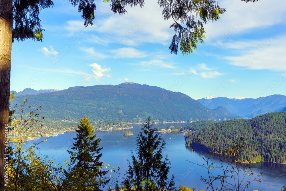 Tranquil waters of Burrard Inlet, BC, Canada, nestled among mountains, as seen from Burnaby Mountain Park, on a clear, crisp, Fall day.