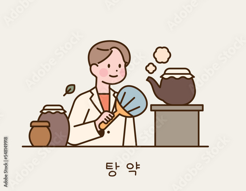 A doctor is making medicine in the traditional way. She is boiling a kettle and fanning it.