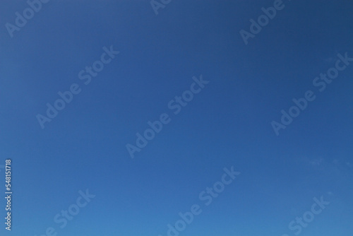 blue sky with minimal clouds with sunshining ray on at noon