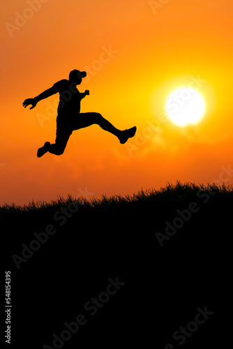 Vertical silhouette of a man jumping to the future. The concept of moving on to something better © STOCK PHOTO 4 U