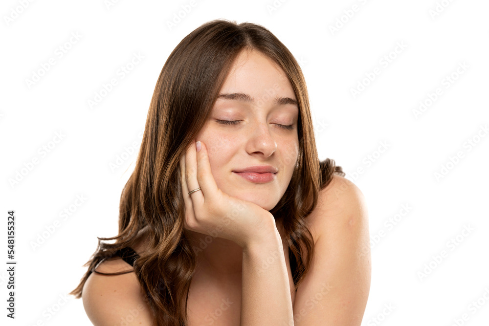 beautiful young women with long hair, no makeup and closed eyes on a white background. beautiful young women with long hair, no makeup and closed eyes on a white background.