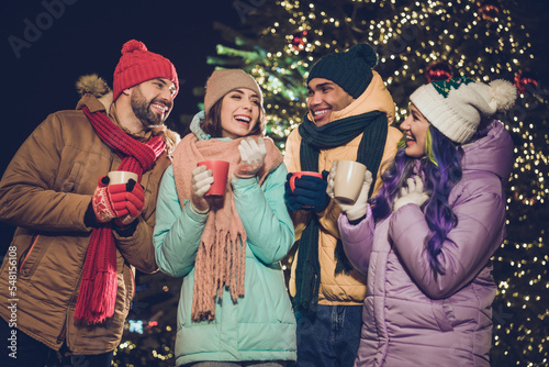 Photo of group positive cheerful people enjoy hot chocolate speak communicate noel miracle outdoors