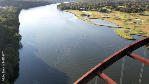 Aerial drone shot of Pennyback bridge with cars passing by in Austin, Texas, USA over Lake Austin at daytime. photo