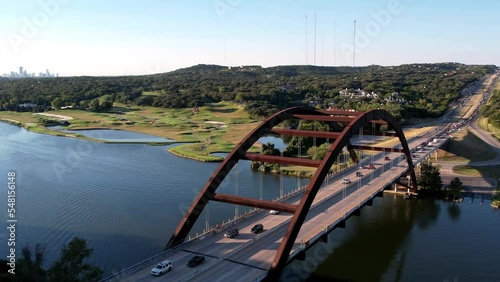 Aerial drone pan shot of Pennyback bridge with cars passing by in Austin, Texas, USA over Lake Austin at daytime. photo