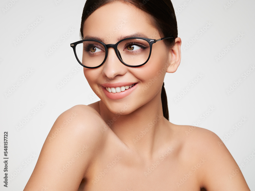 Close up of young woman with eyeglasses on white background. Vision correction. Poor eyesight. Spectacle frame. Makeup, cosmetics, beauty Close up of young woman with eyeglasses on white background. Vision correction. Poor eyesight. Spectacle frame. Makeup, cosmetics, beauty