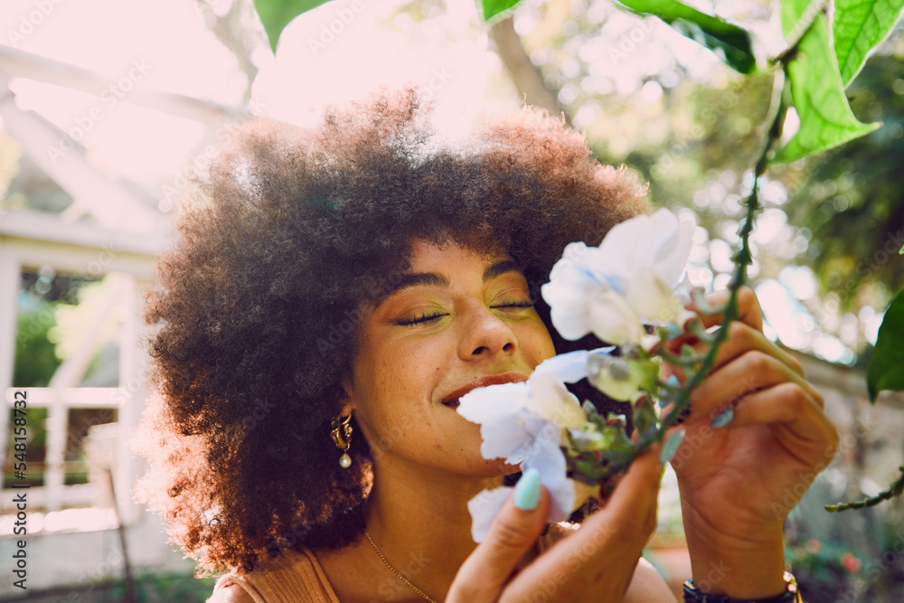Woman, smell flowers and spring garden enviroment for plants wellness or sustainability. African person, green energy and smelling floral fragrance or gardening, ecology and happiness in nature - obrazy, fototapety, plakaty 